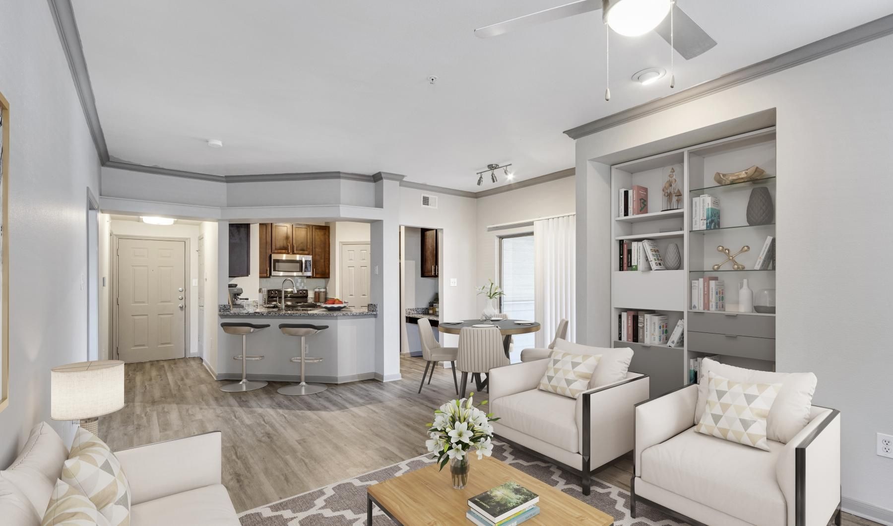 a living room with white furniture