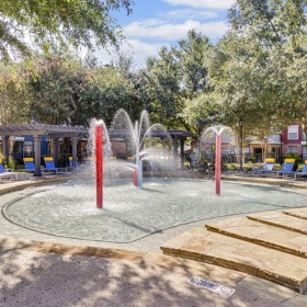 A perfect fit for the whole family a water fountain surrounded by lounge chairs