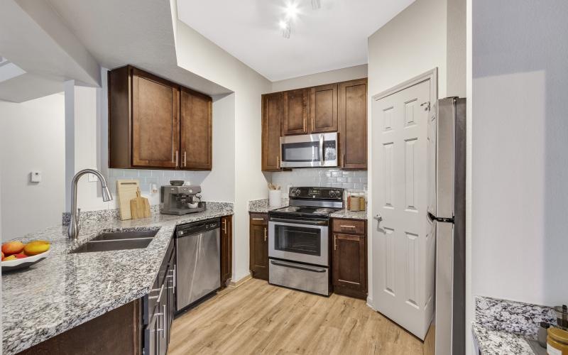 a kitchen with wooden cabinets